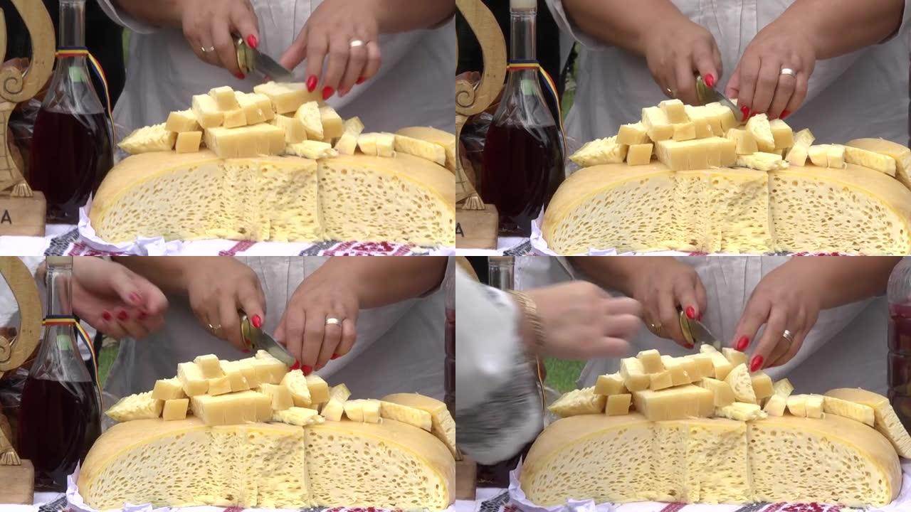 红色指甲的女人用小刀切开小奶酪块，将其放在另一位女士从中品尝并品尝72的流行毛巾上