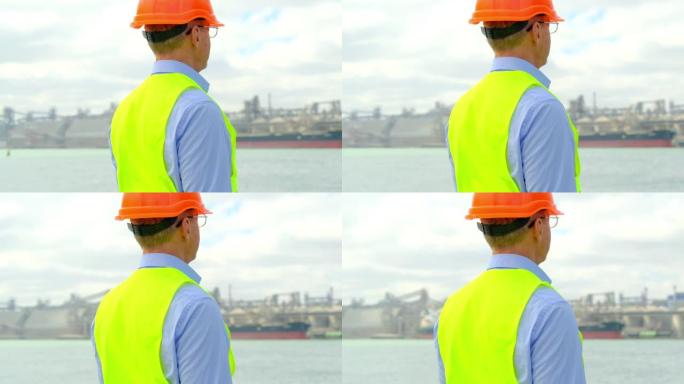 戴着眼镜的海运港口行业工程师看着粮仓
