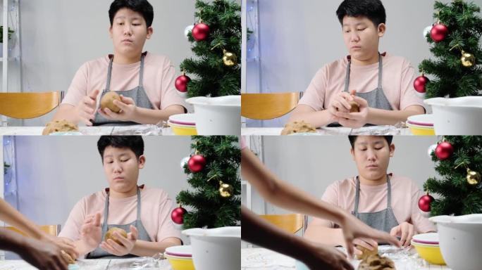 亚洲儿童在成型自制饼干以庆祝圣诞节之前先包裹糕点面团，这是生活方式的概念。