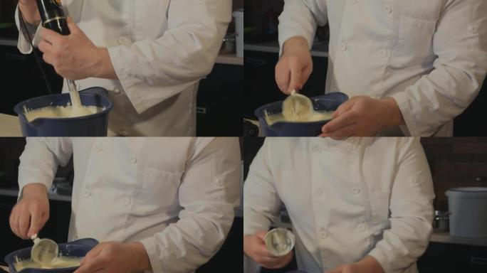 男糕点厨师用搅拌器搅打完奶油，轻敲碗上剩余的奶油，然后取出搅拌器