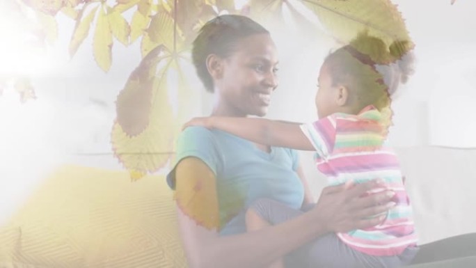 快乐的非洲裔美国母女拥抱树叶的动画
