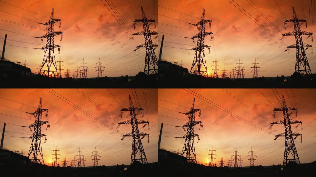 日落时高大的电塔。高压电线通过电缆分配电力。晚上有金属塔架的配送站。慢动作。