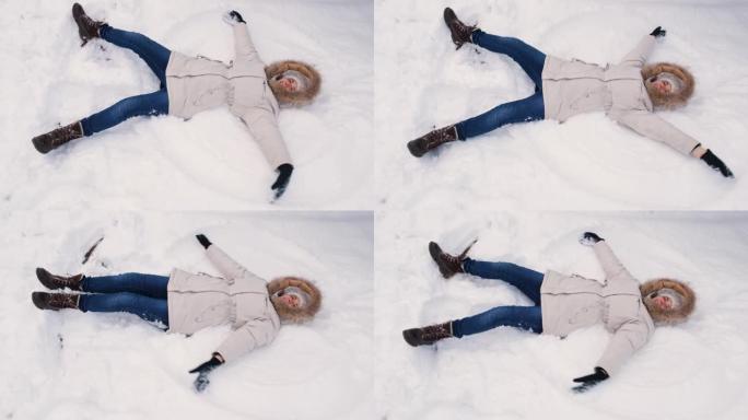 一个穿着白色外套的女人躺在雪地里，上下举起双手，仿佛拍打着翅膀，使天使