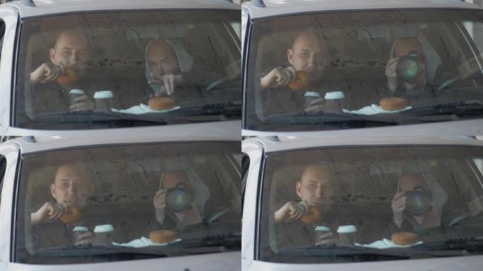 两名男子坐在汽车上，用专业相机，私人侦探或狗仔队间谍拍照。