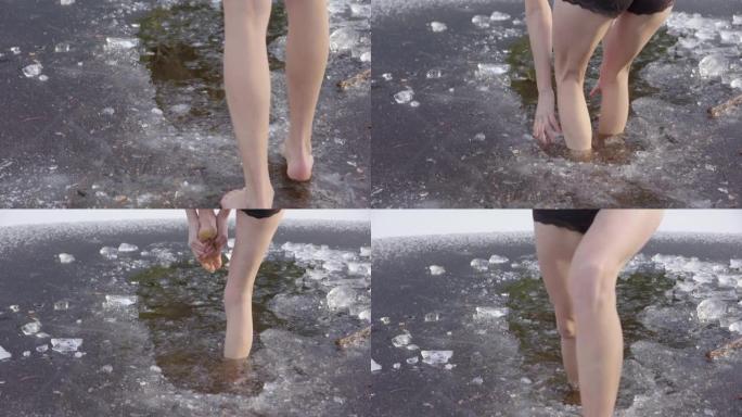 一个年轻女子的美丽腿走进冰冷的水中，跳了出来