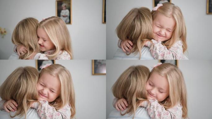 快乐的童年，可爱的女孩子在家庭度假期间紧紧拥抱她的爱的妈妈，特写