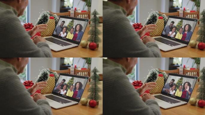 快乐的高加索高级男子在圣诞节与家人进行视频通话