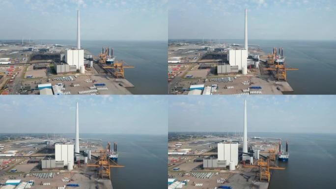 埃斯比约市的鸟瞰图，煤炭和石油燃料发电厂的港口和斯堪的纳维亚半岛最高的烟囱旋转缓慢