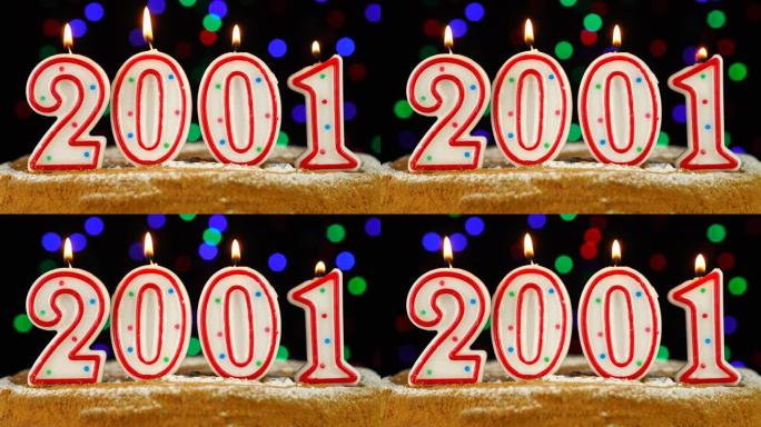 生日蛋糕与白色燃烧的蜡烛在数字2001的形式