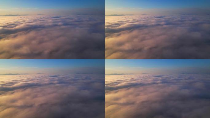 4k无人机在云中飞行。日出时飞越云层，无人机的空中顶部云景