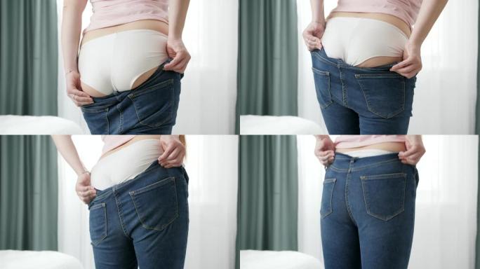 年轻肥胖的女人，大腿大，臀部宽，在底部拉紧牛仔裤。超重、肥胖女性、节食和超重问题的概念