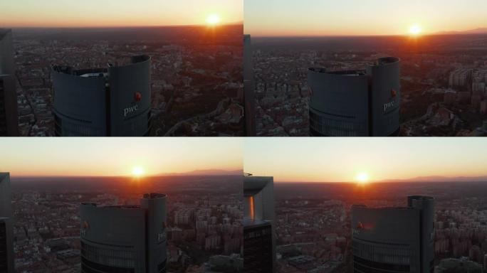 在Cuatro Torres商业区的普华永道塔顶飞行。现代高层办公楼。反对夕阳的观点