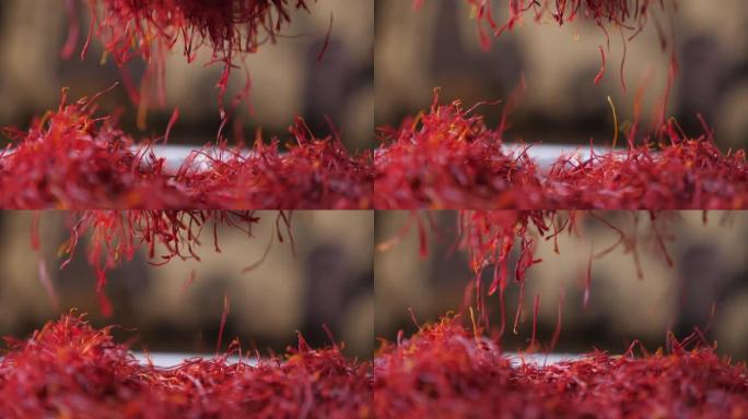 人类用手磨碎的藏红花香料使其在slo-mo中掉落细条纹