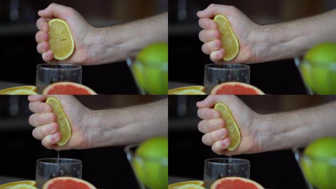 男性的手正在挤压成熟的柠檬来制作柑橘汁，健康的生活方式，果汁