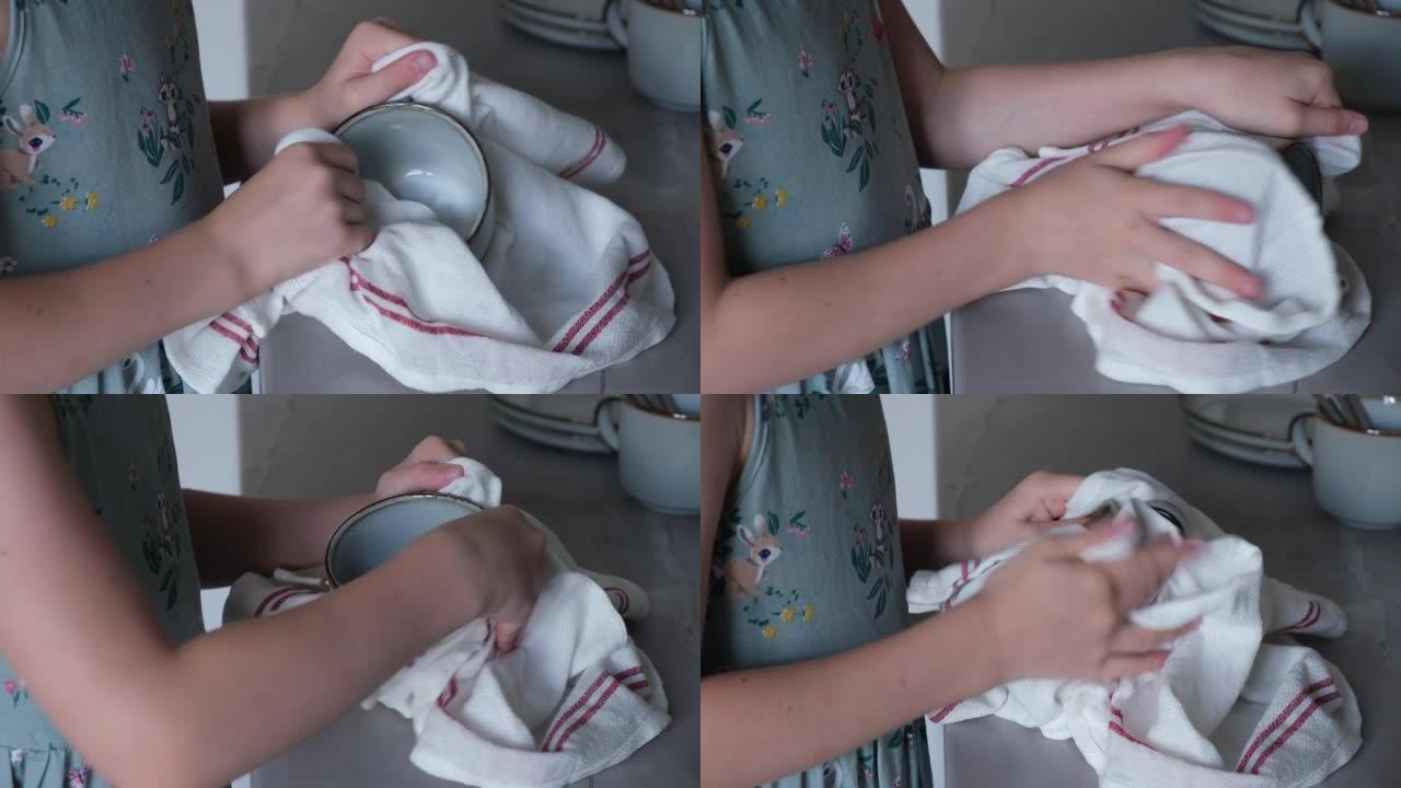 小女孩用毛巾擦杯子，在厨房里帮助妈妈