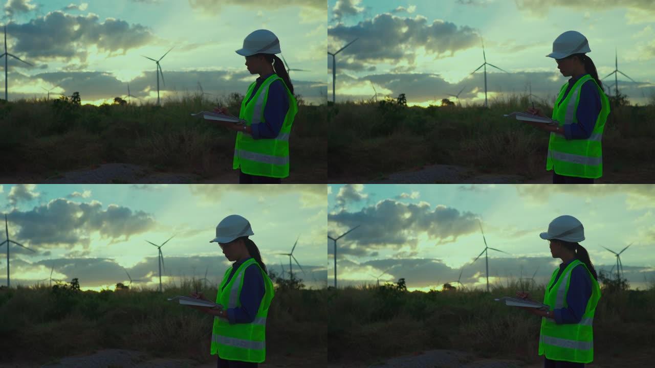 女性工程师使用智能手机在风力涡轮机农场工作的视频。