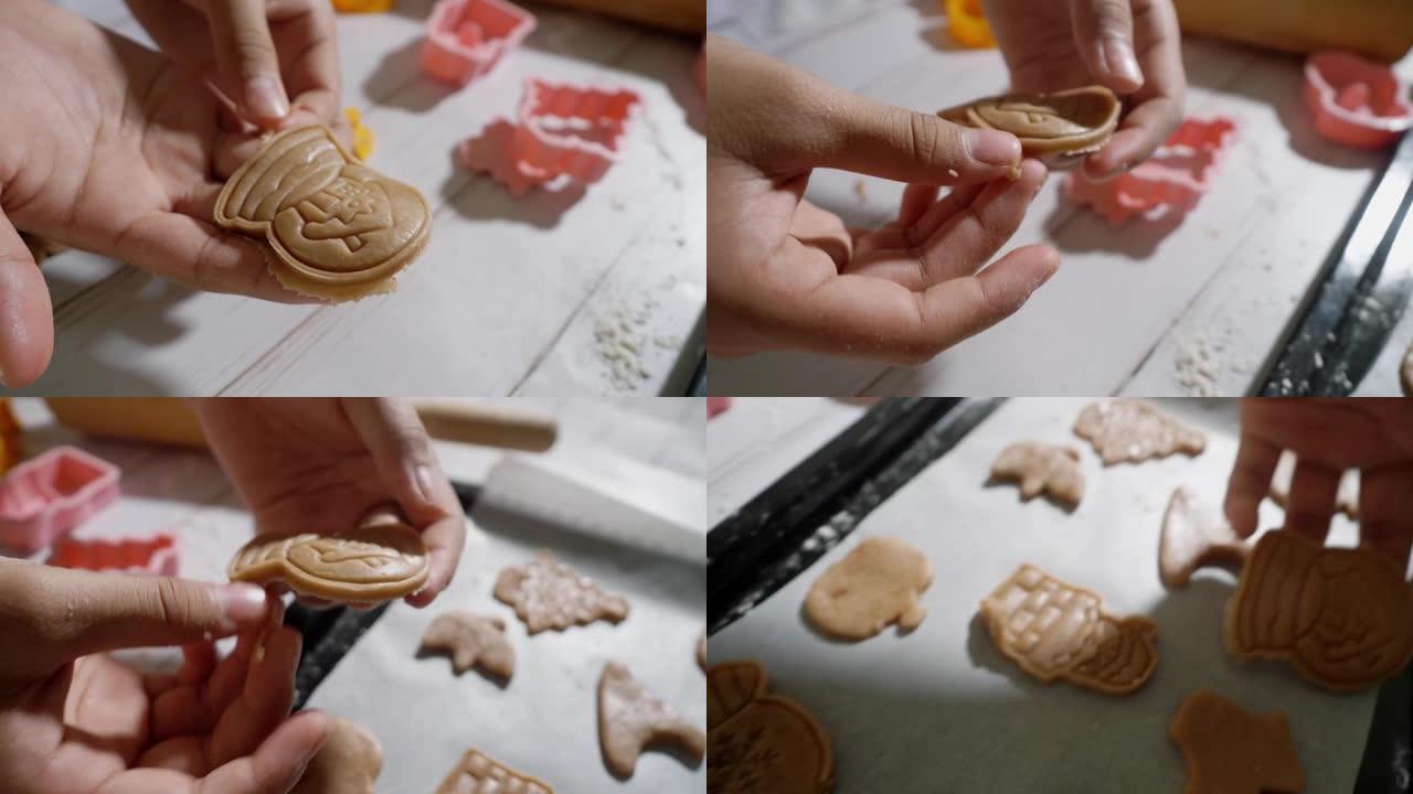 儿童的手使用饼干切割器成型自制饼干，庆祝圣诞节，生活方式的概念。