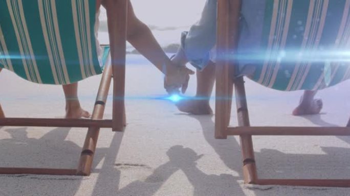在沙滩躺椅上，牵着手的灯光在高级夫妇身上移动的动画