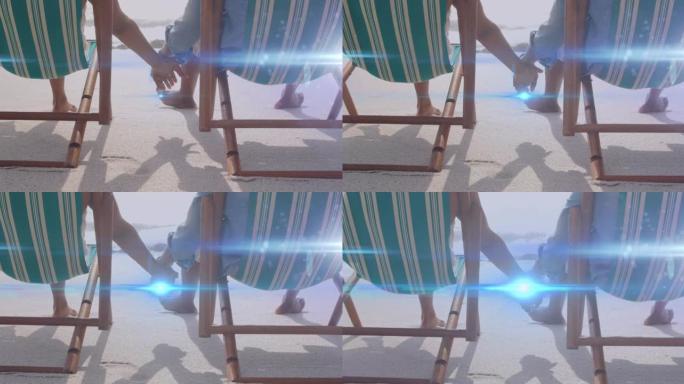 在沙滩躺椅上，牵着手的灯光在高级夫妇身上移动的动画