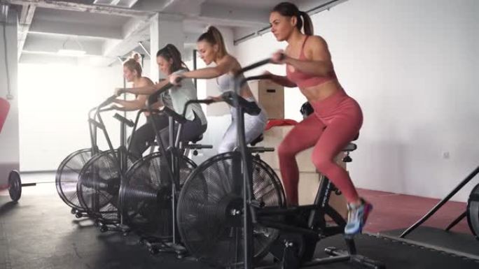 活跃健康的高加索女运动员，在固定的骑行器上锻炼