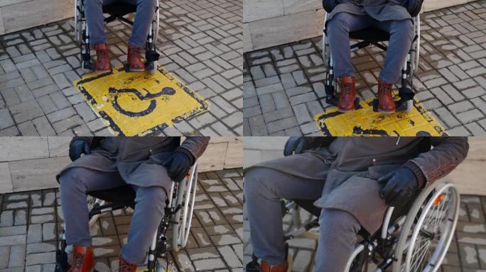 瓷砖街道地板和坐轮椅的男子上的残疾黄色标志