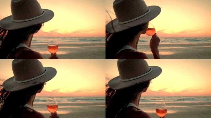 举行葡萄酒课的女人看着海洋上的日落，欣赏着令人惊叹的景色。慢动作
