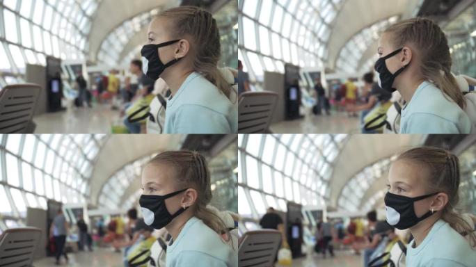 在飞机背景下，在机场戴防护医用口罩的高加索儿童。冠状病毒sars-cov-2新型冠状病毒肺炎2019
