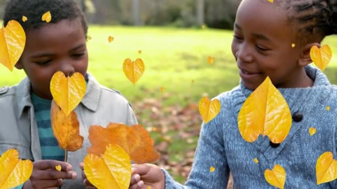 秋叶的动画落在公园里快乐的非洲裔美国男孩和女孩身上
