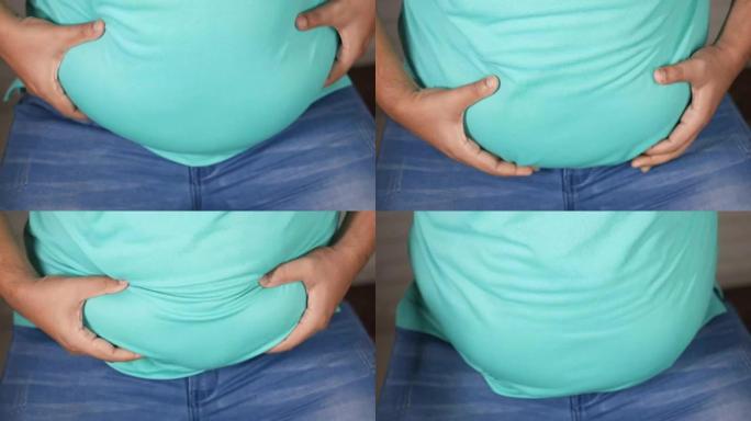 男人的手握着过多的腹部脂肪，超重的概念