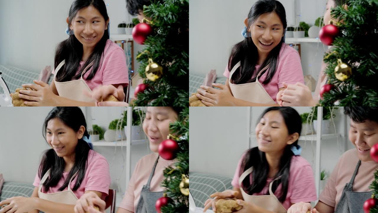 亚洲女孩脱粒糕点面团，然后成型自制饼干来庆祝圣诞节，生活方式概念。