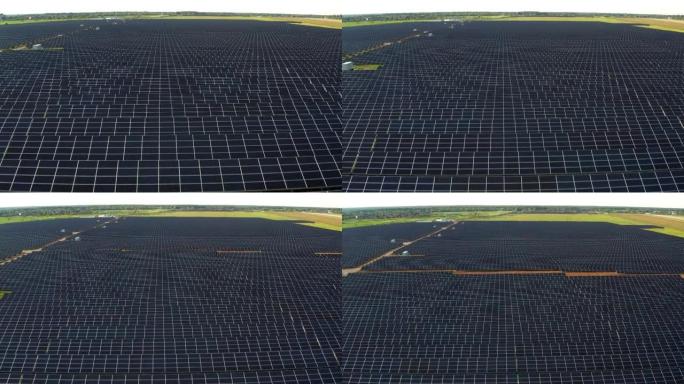 带有太阳能电池板的发电厂的俯视图。美丽的绿色田野。