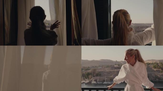 走向房间窗户的年轻女子打开窗帘，走到阳台上。埃及阿斯旺早上壮观的河景和帆船