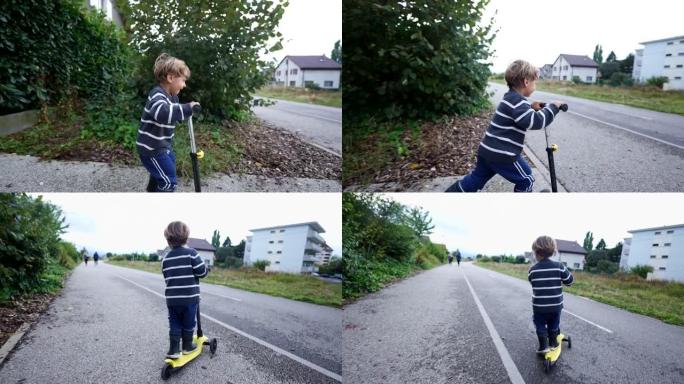 小男孩在外面骑三轮踏板车，快乐的孩子骑踏板车