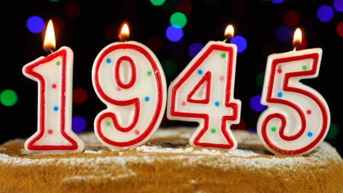 生日蛋糕与白色燃烧的蜡烛在数字1945的形式