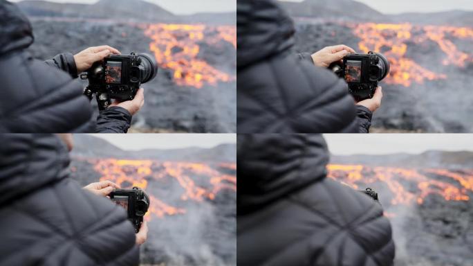 摄影师用熔岩流调整三脚架上的相机