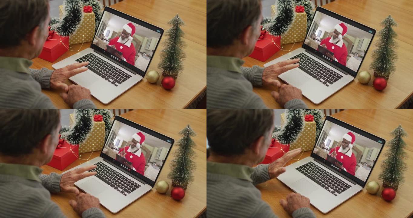 快乐的高加索高级男子在圣诞节与圣诞老人进行视频通话