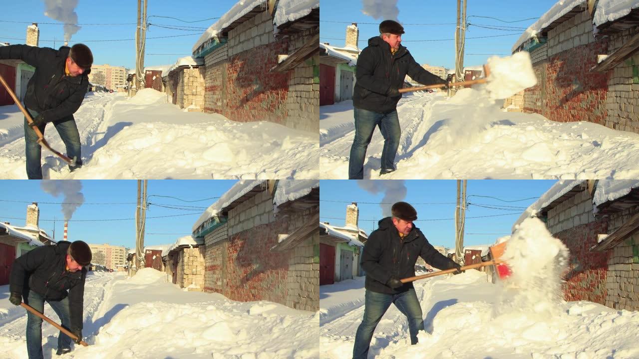 一个穿着暖和衣服的人拿着铲子清除了积雪的道路。