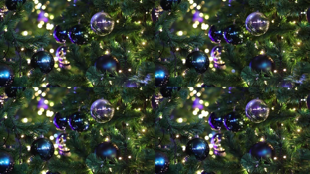 新年照明背景上的杉木树枝上的新年五彩球
