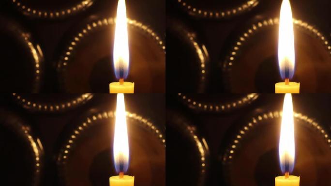 一支在微风中摇曳燃烧的蜡烛闪耀着美丽的光芒