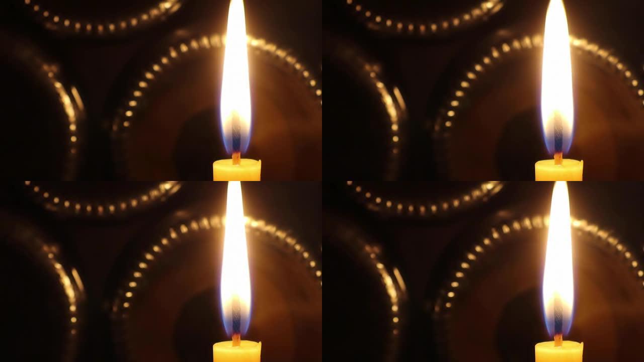 一支在微风中摇曳燃烧的蜡烛闪耀着美丽的光芒
