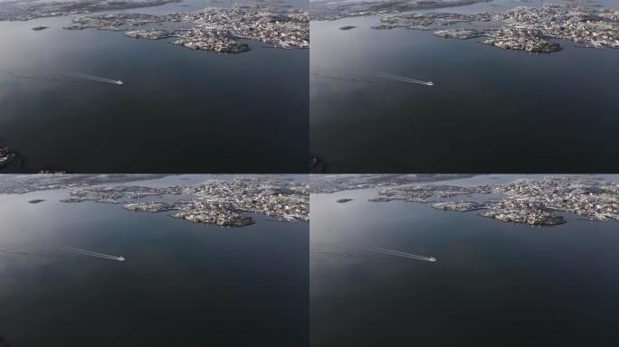 无人驾驶飞机在海洋上看到一艘正在移动的渔船，并带有海洋海浪反射。