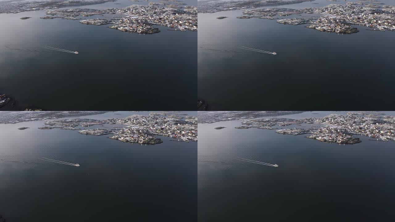 无人驾驶飞机在海洋上看到一艘正在移动的渔船，并带有海洋海浪反射。