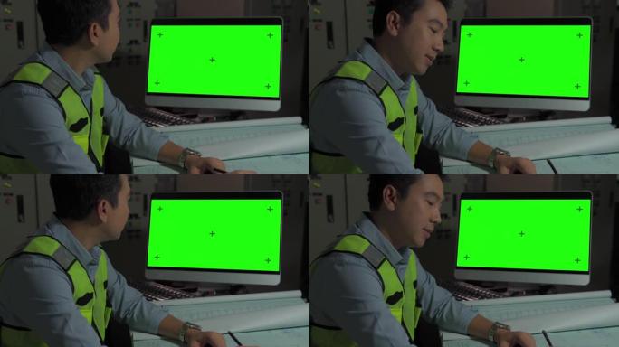 工程师在带有绿色模拟屏幕的个人计算机上工作