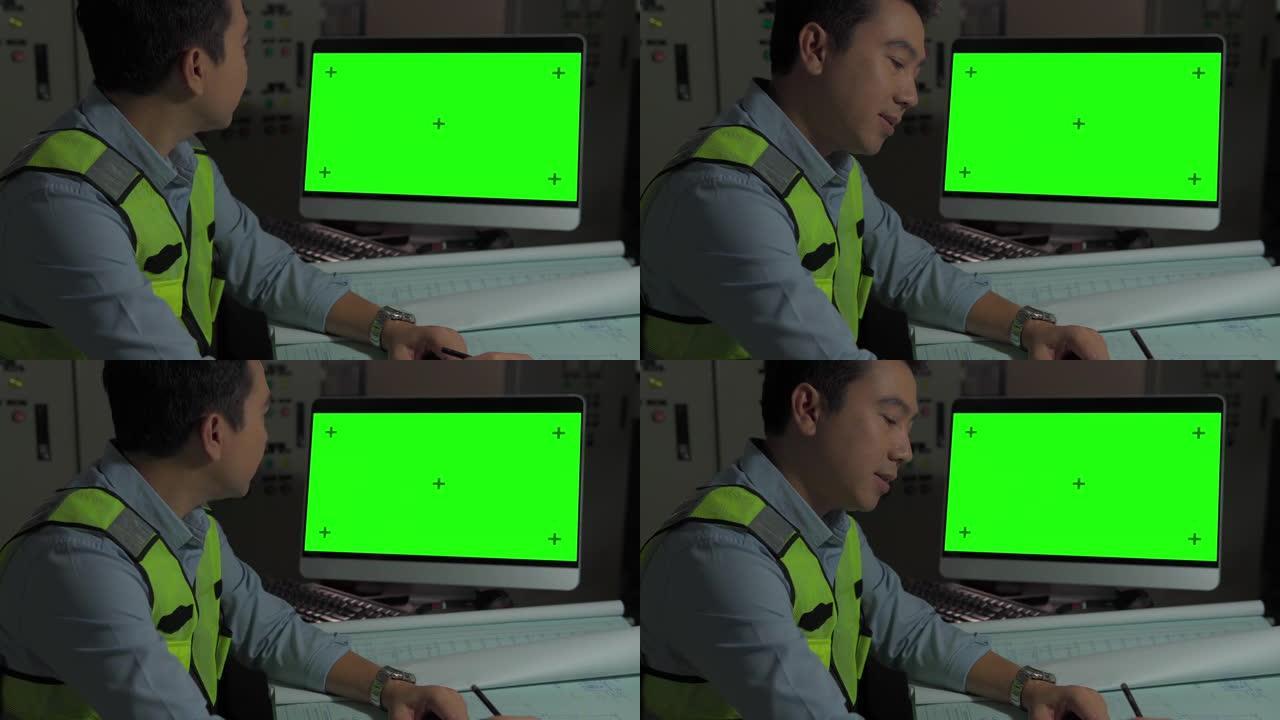 工程师在带有绿色模拟屏幕的个人计算机上工作