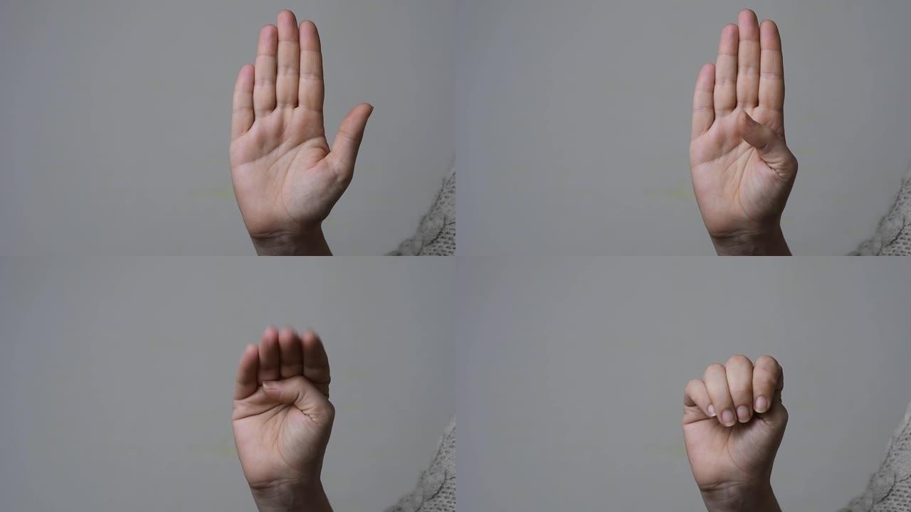 求助信号概念: 女人的慢动作，显示如何做出手势以无声地寻求帮助