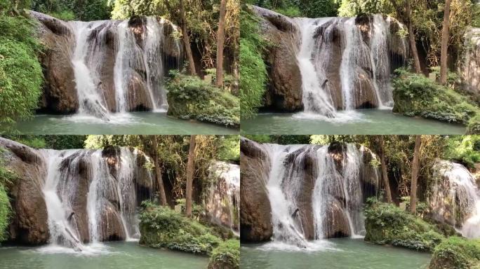 雨林中的瀑布树木中的水流岩石上的水流溪流