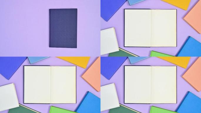 深蓝色精装书出现在紫色主题上，打开，鲜艳的色彩书籍出现在制作框架周围。停止运动平铺