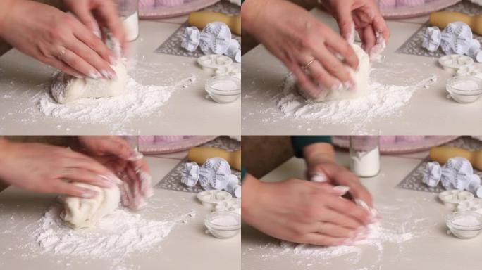 一个女人用糖粉制作糖果乳香。用手揉捏。特写。