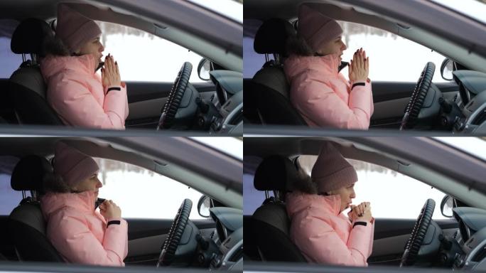 试图在汽车上取暖的女性吹手