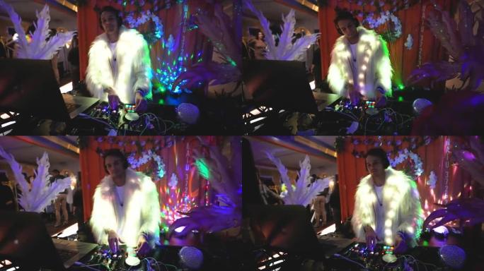 男性dj用遥控音频控制台表演。电子派对夜生活。